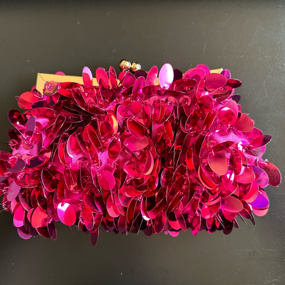 Hot pink sequence clutch with gold hardware.